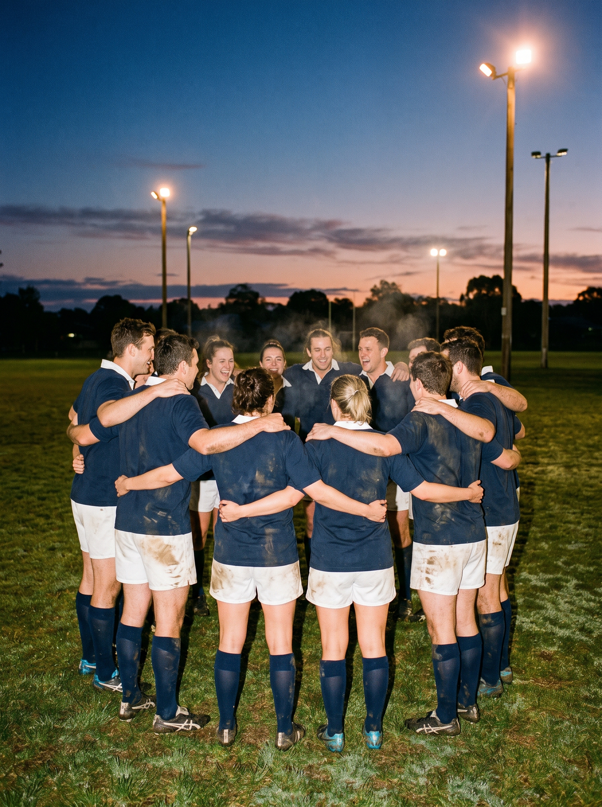Amateur football club team in matching polos on a suburban oval